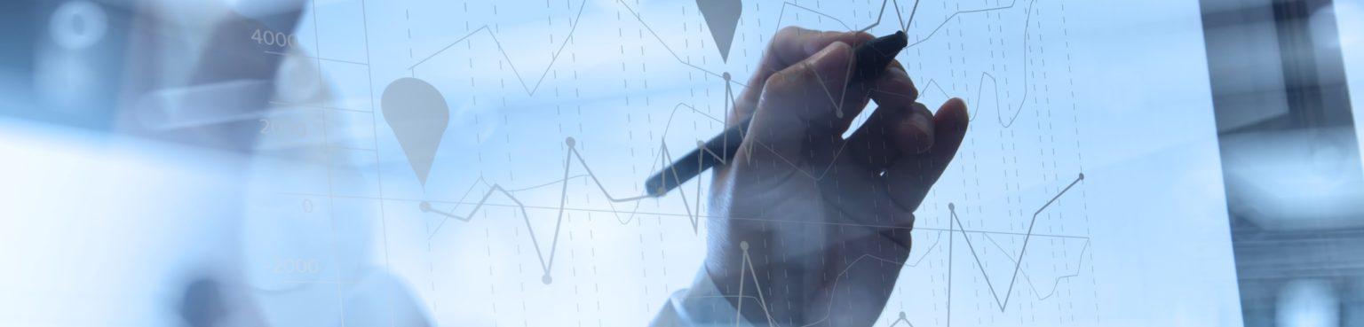 Abstract image of graphs and a hand writing annotations