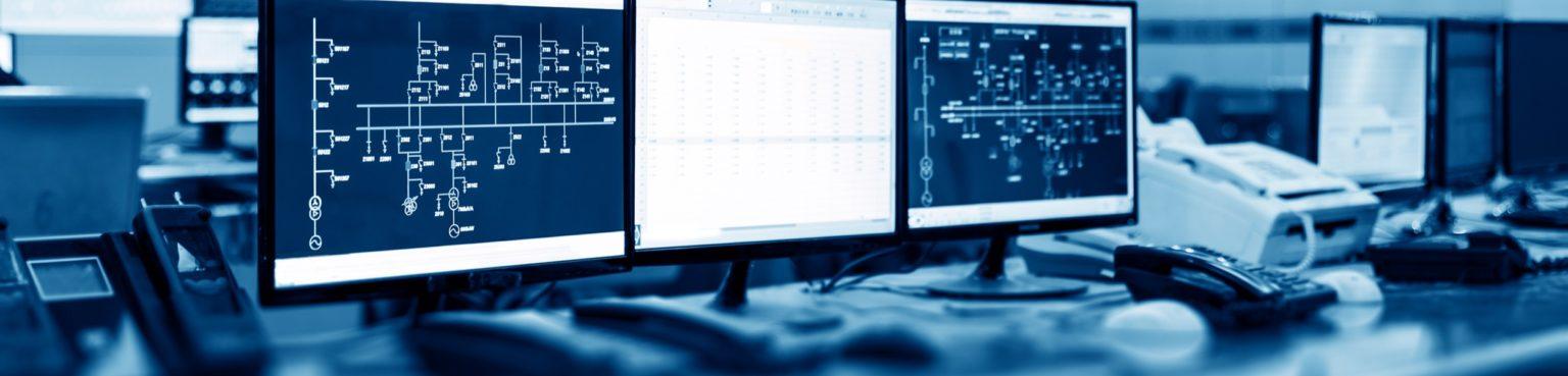 Three monitors displaying software