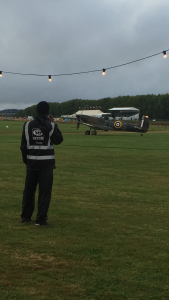 A marshal observing a vintage aircraft