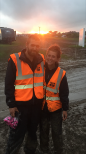 A couple of marshals posing for a photo in front of a sunset
