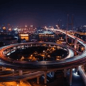 Cars with a dashed line effect on a winding bridge.
