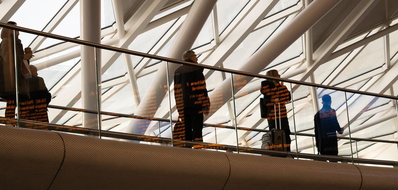 Workers walking across a walkway.
