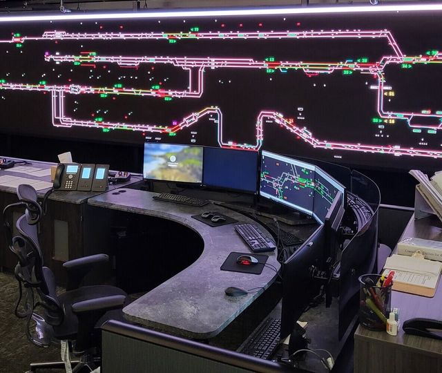A control room with lots of computer screens.