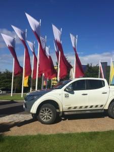 A vehicle parked in front of flags