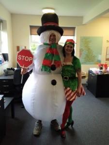 SEP staff dressed as a snowman and elf pose for a photo