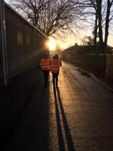 Two marshals walking towards the sunset