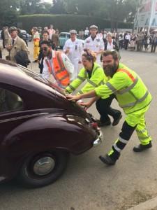 Marshals pushing a vintage car