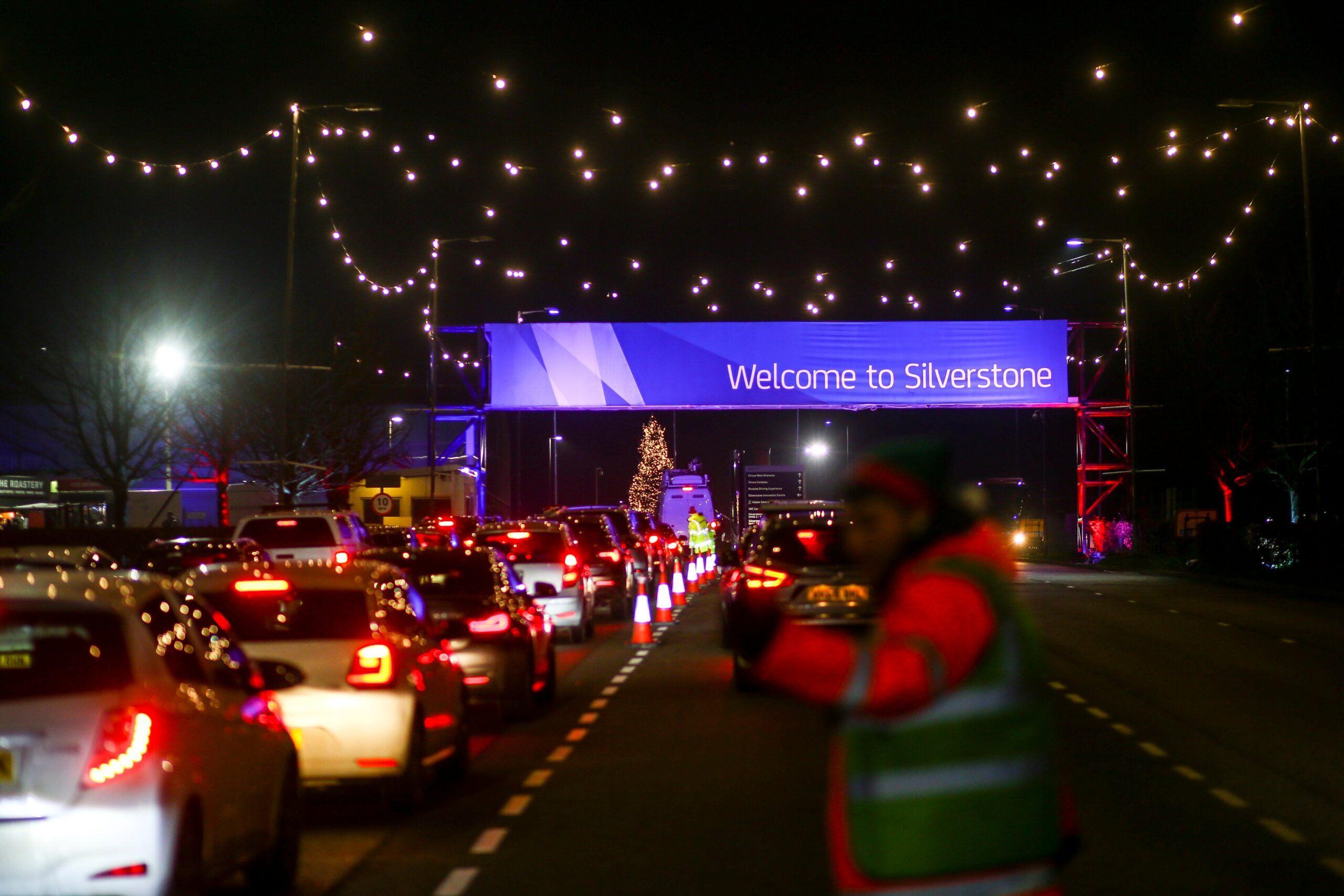 Vehicles arriving at Silverstone at night.