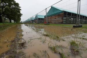 A waterlogged track along side a fence