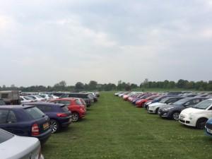 Rows of vehicles parked in a field