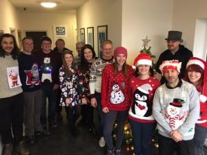 The SEP team wearing Christmas jumpers, pose for a photo