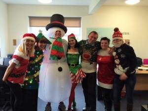 SEP staff in Christmas outfits, pose for a photo