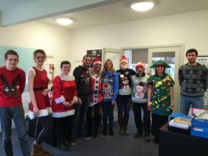 SEP staff in Christmas outfits, pose for a photo