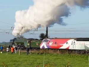 Spectators watch a steam locomotive