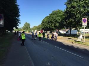 Spectators crossing a road