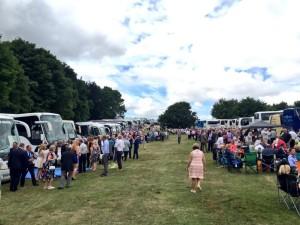 Coaches parked in a field