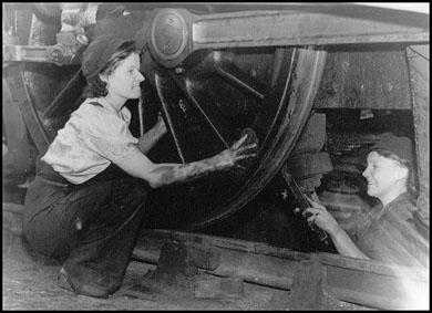 a woman cleaning a train wheel