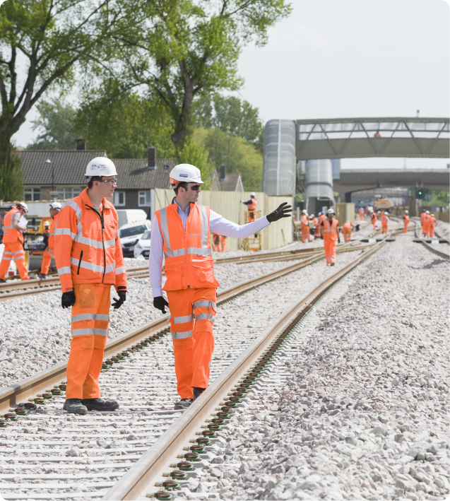 Rail workers discussing plans for rail track