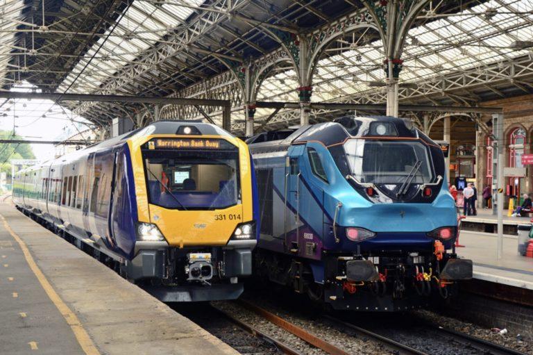 Two trains waiting at a station