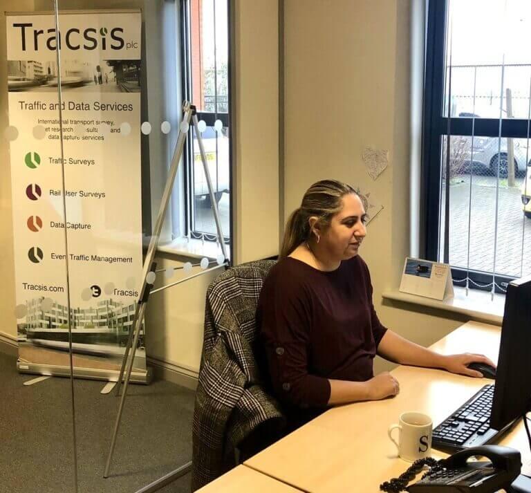 Tracsis employee at desk.