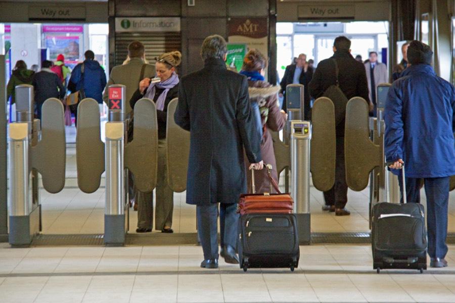 Passengers using ticketless turnstiles at a railway station