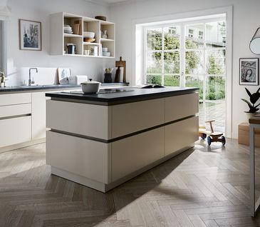 Cremefarbene Küche mit Essplatz und roten Accessoires