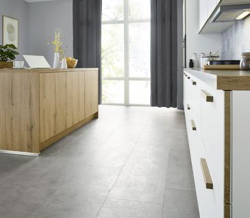 Nahaufnahme von Küchenfront mit weißen Schubladen und Akzenten in Vulkaneiche-Optik.