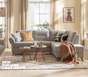 Modernes Ecksofa mit grauem Stoffbezug und Schlaffunktion mit Bettkasten.