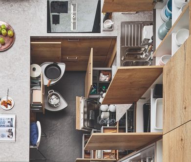 Küche aus Vogelperspektive mit offenen Schränken und Schubladen