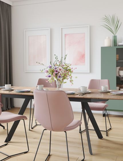 Modernes Esszimmer in Pastellfarben mit rosa Stühlen, Esstisch aus Eiche und Highboard in grün.