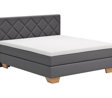 Graues Boxspringbett mit Matratze