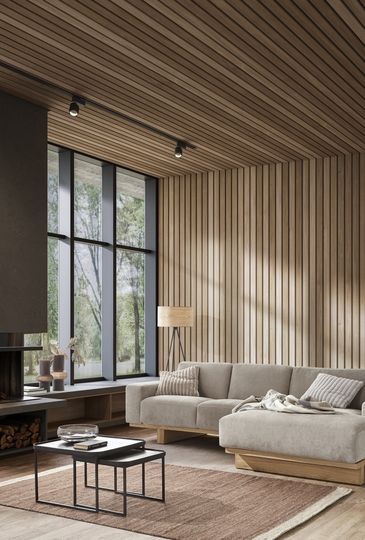 Natürlich eingerichtetes Wohnzimmer mit beigem Ecksofa vor holzverkleideter Wand neben Kamin.