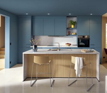 Moderne Inselküche mit Kücheninsel in Grau und Küchenzeile mit blauen Fronten.