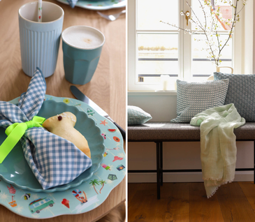 Gedeckter Tisch mit türkisen Tellern und Oster-Deko.