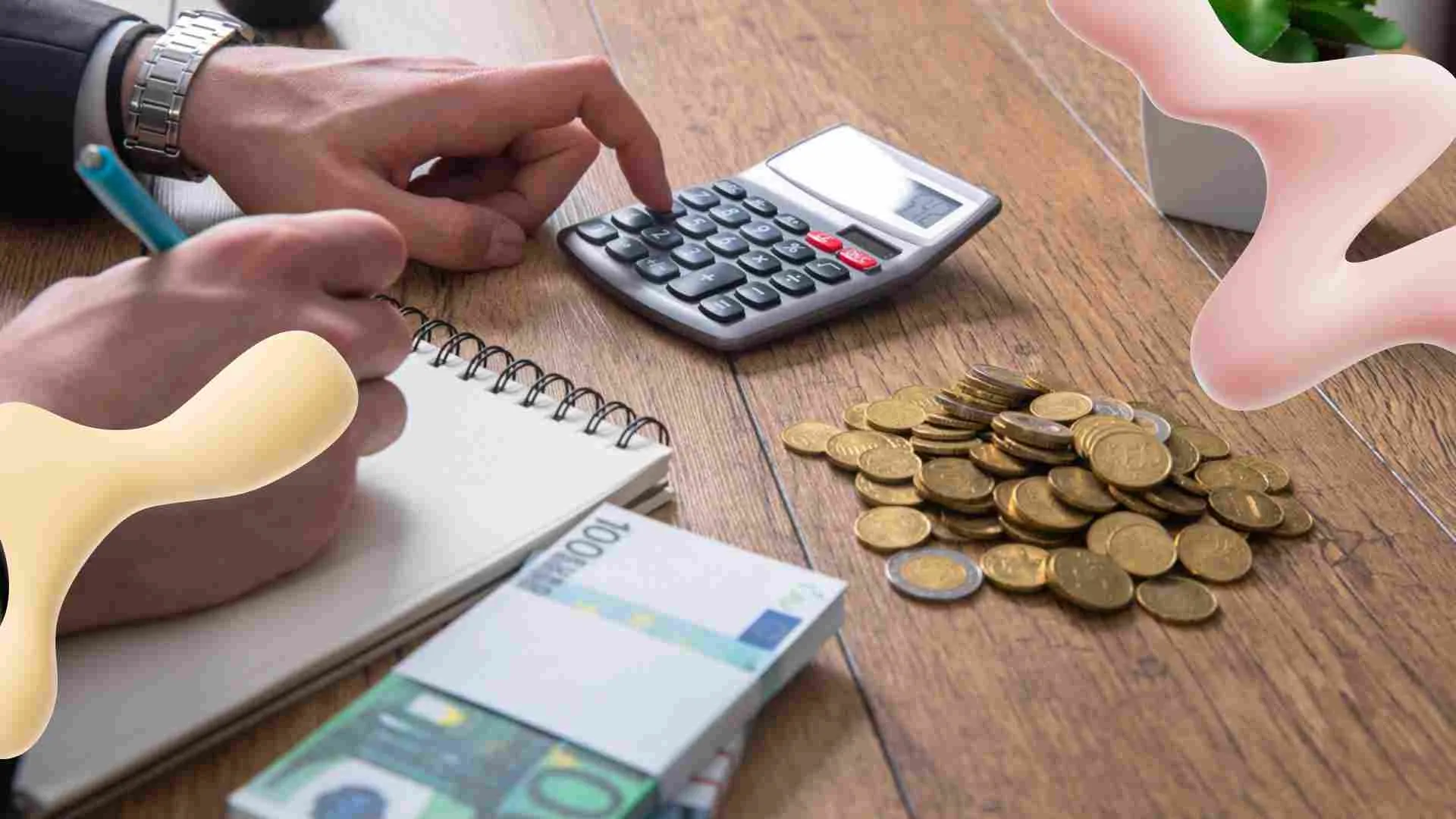 Hands using a calculator and writing in a notebook, with Euro banknotes and coins on a wooden desk, signifying financial tasks.