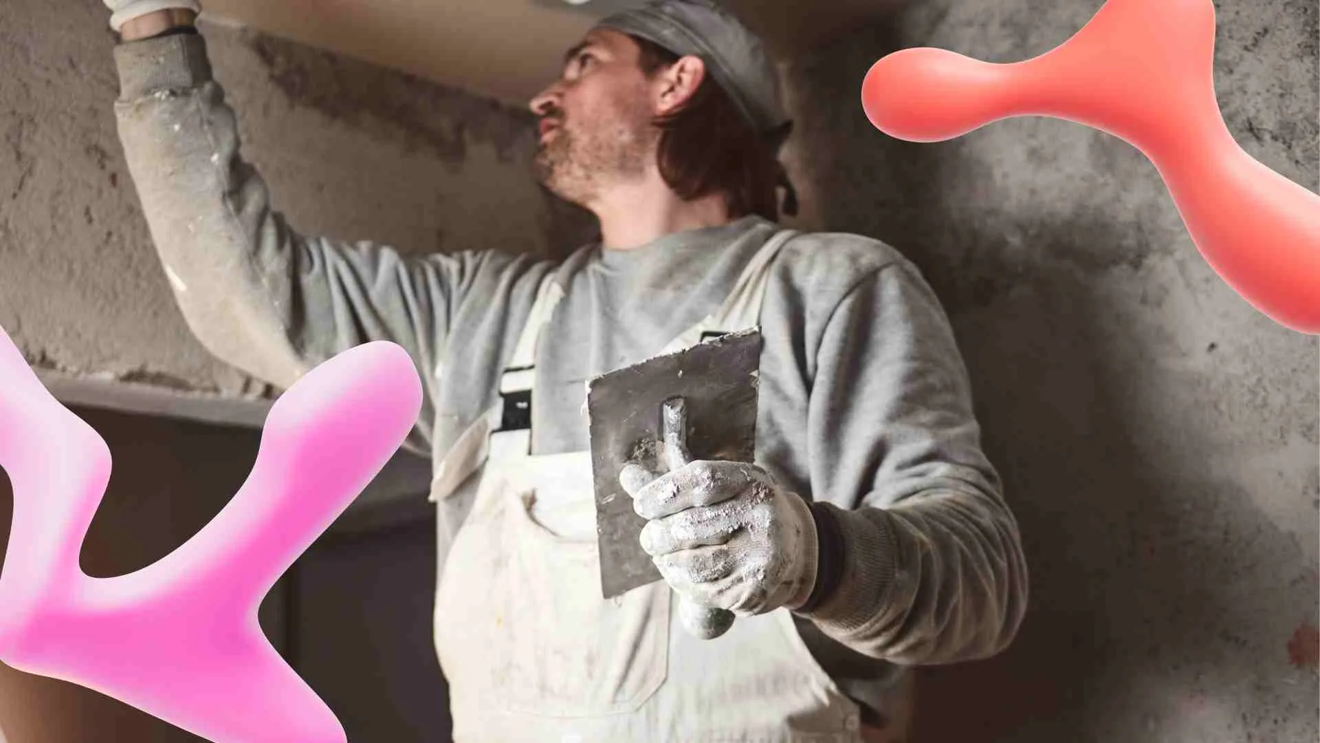 Man in work clothes and gloves applying plaster with a trowel to a wall, partially obscured by large pink and red abstract shapes.