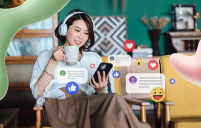 A smiling woman wearing headphones and holding a mug looks at her phone, surrounded by floating social media likes, hearts, and comments.
