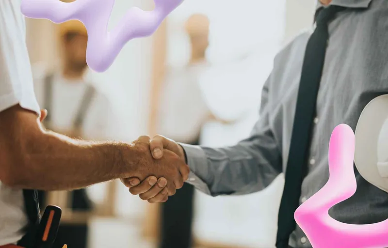 Construction worker and supervisor shaking hands on a job site, overlaid with abstract pink and purple shapes.
