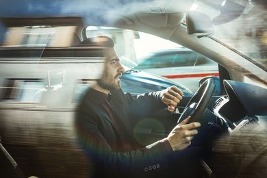 business man driving in car