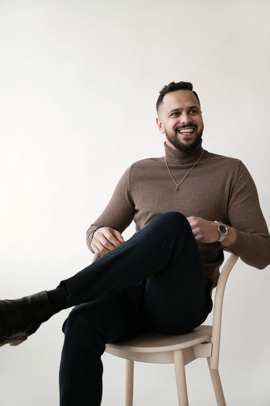 Man with a big smile sitting on a chair