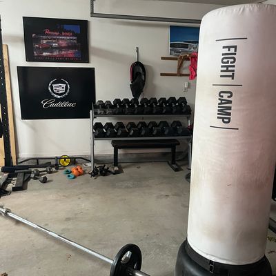 FightCamp bag in home gym with weights and barbell