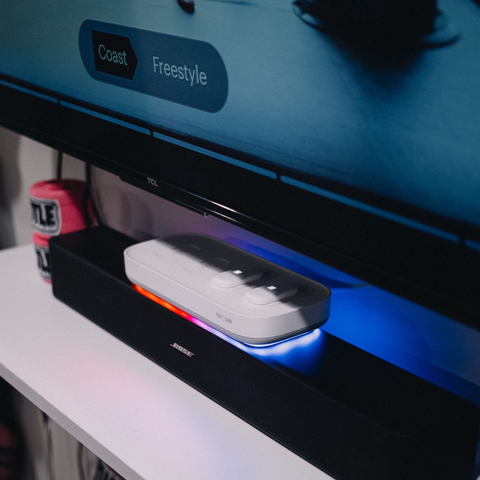 Console sitting on tv console, workout playing on screen.