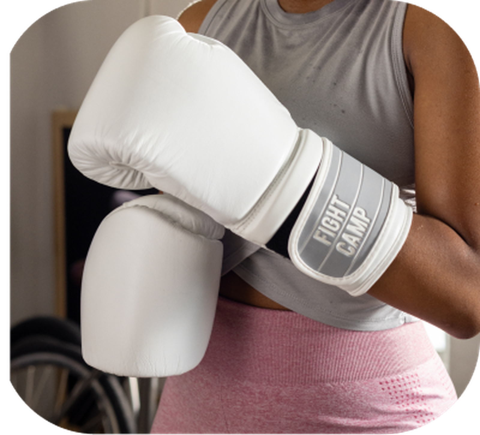 A person wearing FightCamp boxing gloves