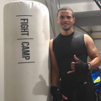 Man standing next to FightCamp bag