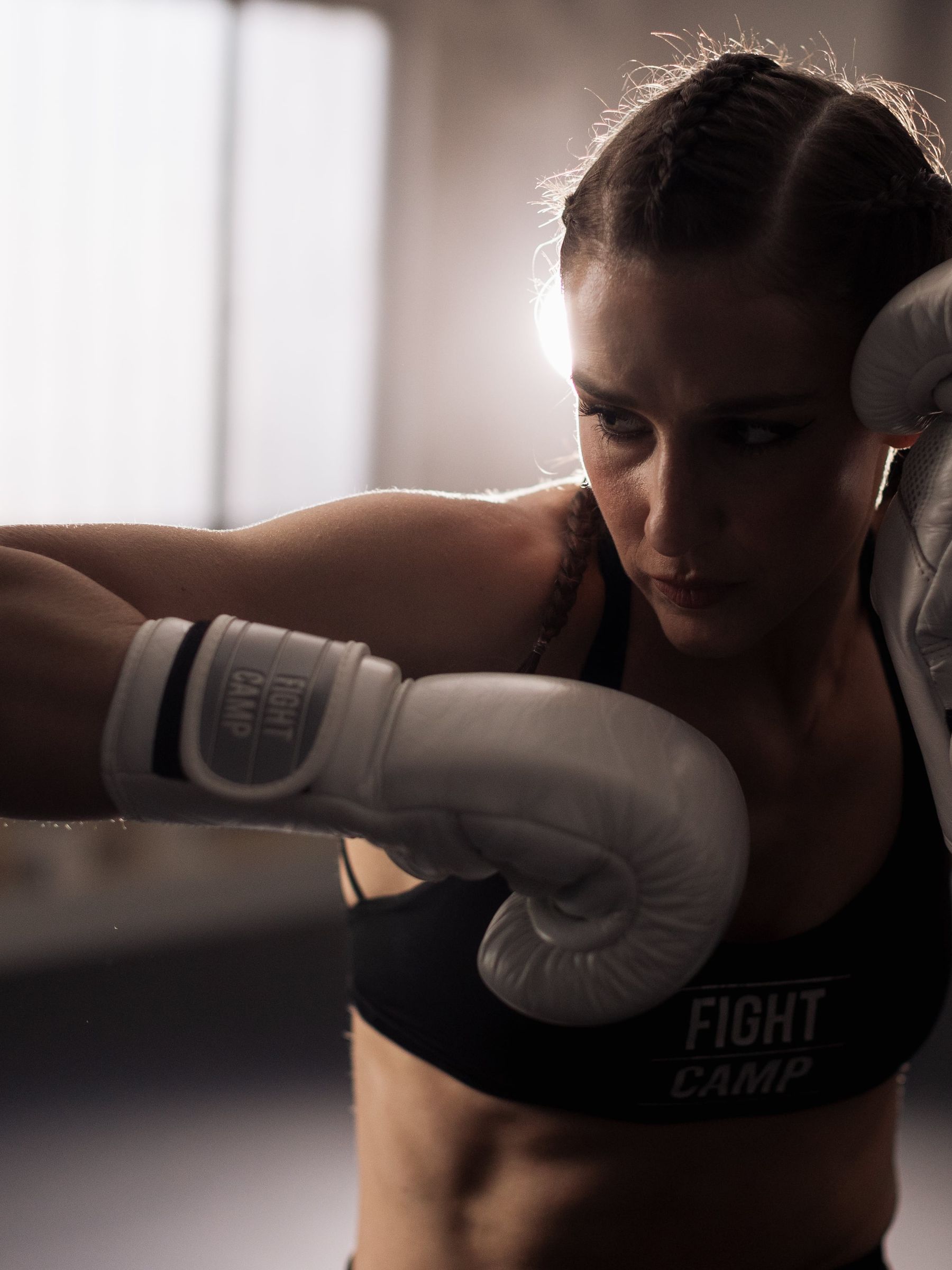 Coach Jess striking a punching bag with her elbow