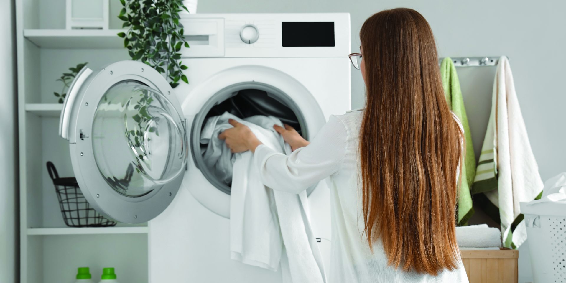 Lady putting clothes in dryer