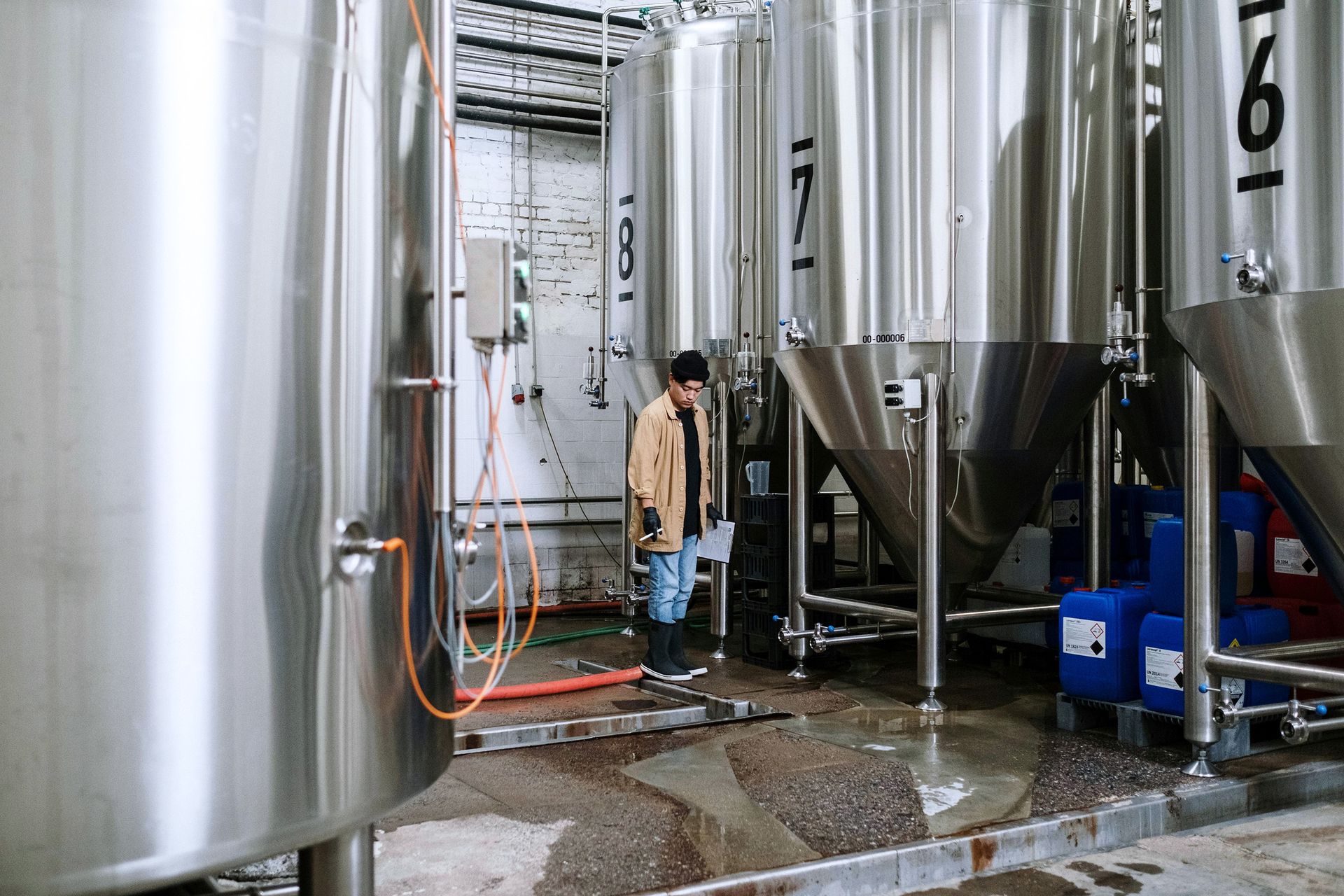 A Man in Brown Jacket in a Brewery
