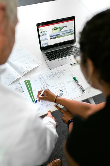 people looking at graphs on a table