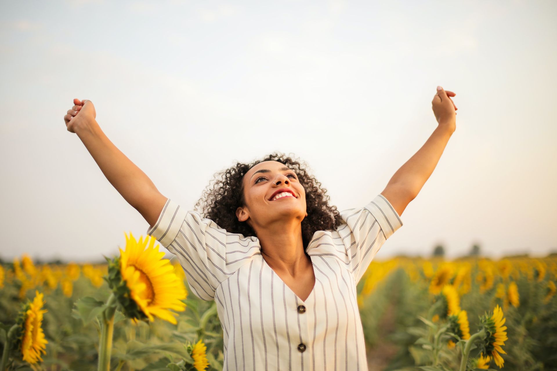 Lady in field with sunflowers