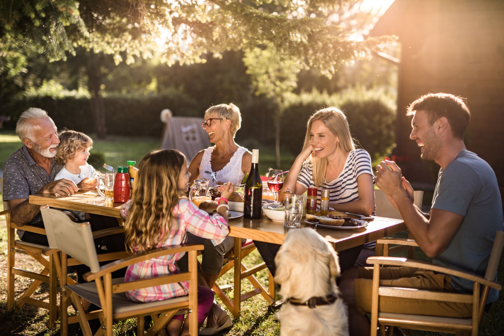 Happy multi-generation family enjoying in lunch time at their backyard.